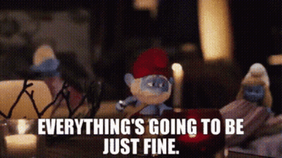 Smurf With Red Hat Sitting Beside Candle GIF