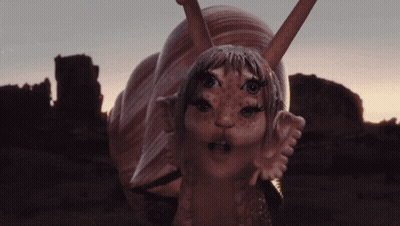 Snail Statue With Girl Face And Ears GIF