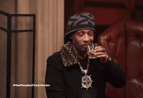 Snoop Dogg Drinking A Glass Of Whiskey With The Peoples Cheerleader Written Below Him GIF