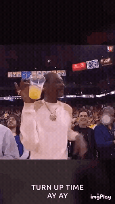 Snoop Dogg Holding Orange Juice in Crowd