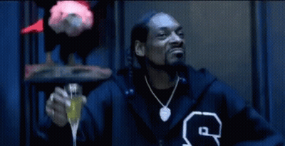 Snoop Dogg In Fur Coat Sitting In Chair GIF