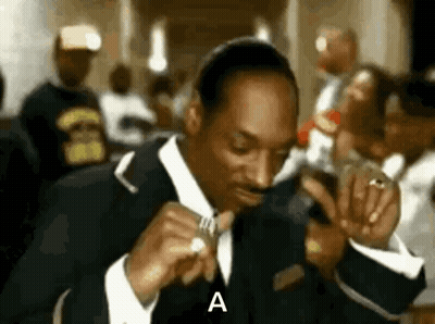 Snoop Dogg In Suit Holding Microphone In Crowd GIF