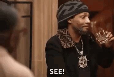 Snoop Dogg Is Holding A Glass Of Whiskey And Talking To A Man . GIF