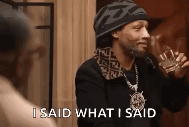 Snoop Dogg Is Holding A Glass Of Whiskey And Talking To A Woman . GIF