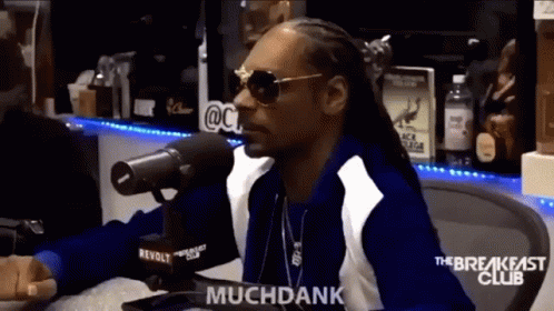 Snoop Dogg Is Sitting In Front Of A Microphone And Says Muchdank GIF