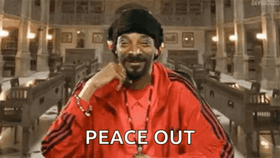 Snoop Dogg Is Wearing A Red Jacket And Hat And Smiling While Holding A Cigarette In His Mouth . GIF