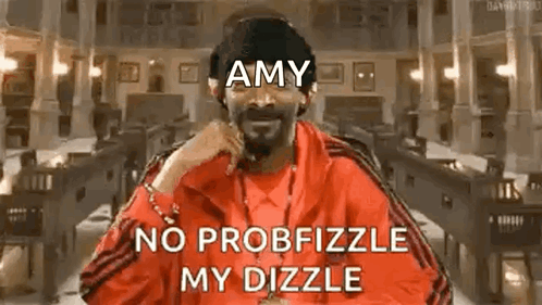 Snoop Dogg Is Wearing A Red Jacket With The Words `` Amy No Probfizzle My Dizzle '' On It . GIF