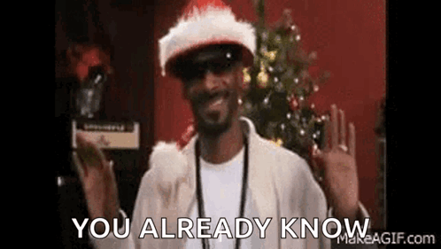 Snoop Dogg Is Wearing A Santa Hat And Sunglasses And Waving . GIF
