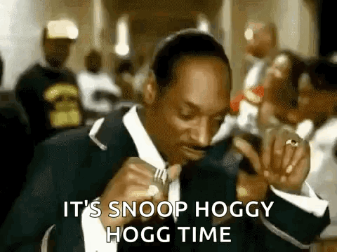 Snoop Dogg Is Wearing A Suit And Tie And Eating A Sandwich . GIF