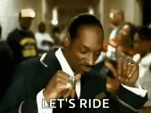 Snoop Dogg Is Wearing A Suit And Tie And Holding A Fork In His Hand . GIF