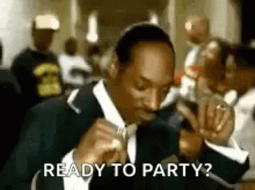 Snoop Dogg Is Wearing A Suit And Tie And Singing Into A Microphone While Eating A Sandwich . GIF