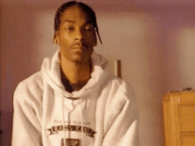 Snoop Dogg Is Wearing A White Hoodie And A White Robe . GIF