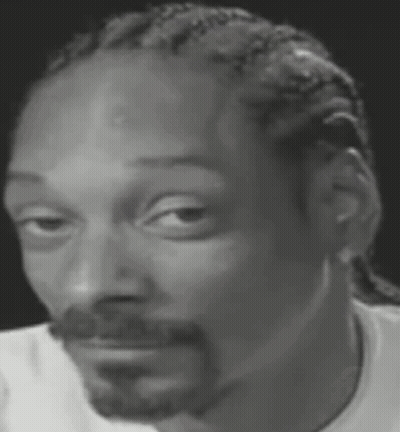Snoop Dogg Is Wearing A White Shirt And Making A Funny Face . GIF