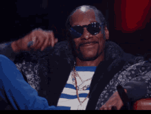 Snoop Dogg Wearing Sunglasses And A Blue And White Striped Shirt GIF