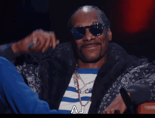 Snoop Dogg Wearing Sunglasses And A Striped Shirt With Aj Written On The Bottom GIF