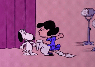 Snoopy And Lucy Kissing On Stage In Front Of Purple Curtain GIF