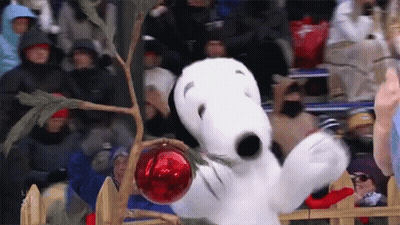 Snoopy Holding Red Ornament In Christmas Tree GIF