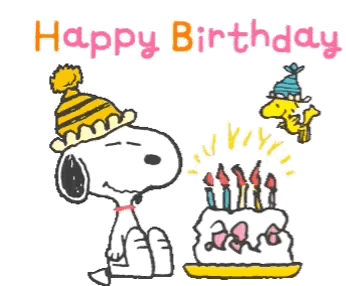Snoopy Is Blowing Out Candles On A Birthday Cake GIF