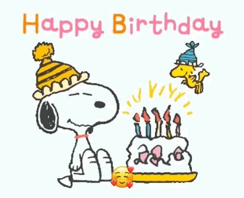 Snoopy Is Blowing Out Candles On A Birthday Cake While Woodstock Looks On . GIF