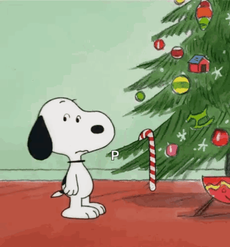 Snoopy Is Looking At A Christmas Tree With A Candy Cane . GIF
