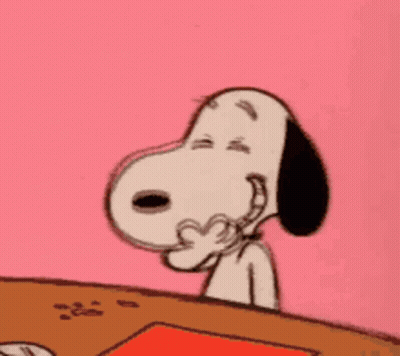 Snoopy Is Sitting At A Table With His Eyes Closed And His Hand On His Face . GIF