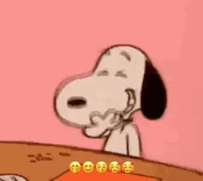 Snoopy Is Sitting At A Table With His Eyes Closed And Making A Funny Face . GIF