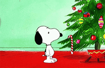 Snoopy Standing Next to Christmas Tree Holding Candy Cane