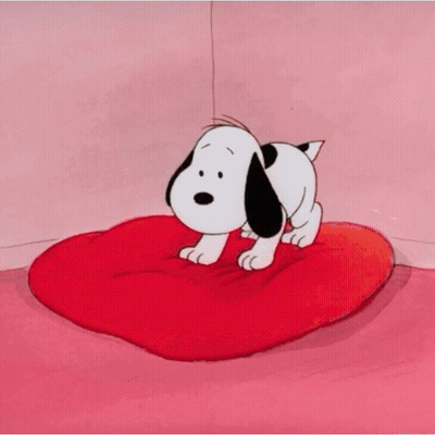 Snoopy Standing On Red Heart Shaped Pillow GIF