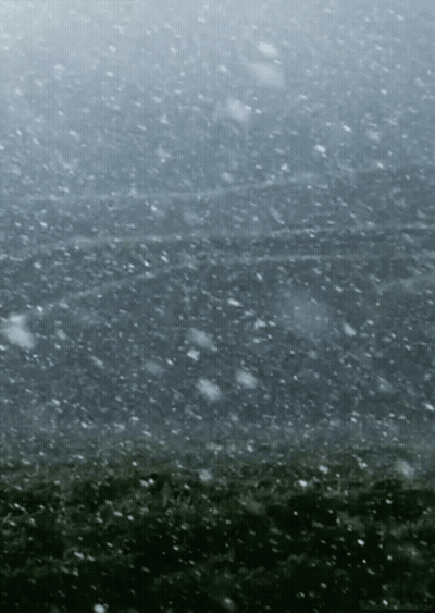 Snow Is Falling On A Dark Gray Background GIF