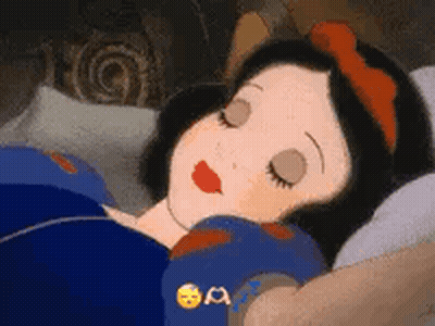 Snow White From Snow White And The Seven Dwarfs Is Sleeping In A Bed With Her Eyes Closed . GIF