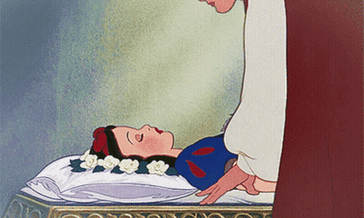 Snow White Laying On Bed With Flowers In Hair GIF