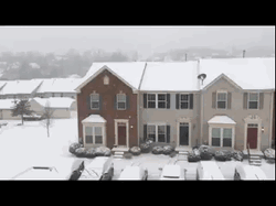 Snowing Over Old Building GIF