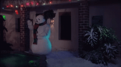 Snowman In Front Of House With Christmas Lights GIF