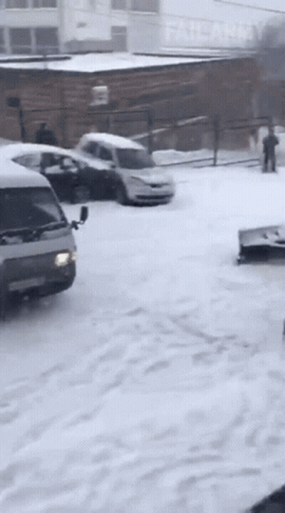 Snowy Parking Lot With Army Building GIF