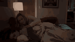 Snuggling Couple In The Dark Room GIF