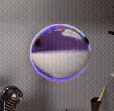 Soap Bubble Floating In Front Of Microphone GIF