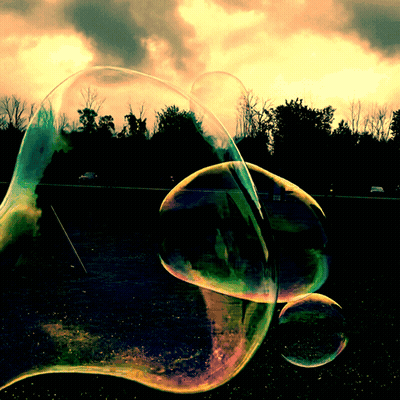 Soap Bubbles Floating At Sunset GIF