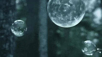 Soap Bubbles Floating In Front Of Rainy Window GIF