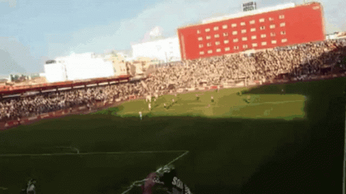 Soccer Game In Stadium With Red Building GIF