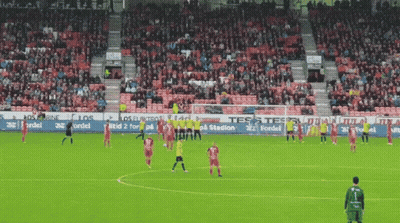 Soccer Game in Stadium With Tes Banner