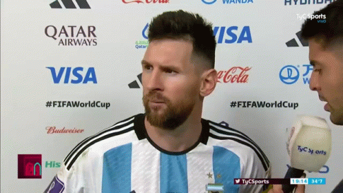 Soccer Player And Reporter With Qatar Airways Visa Coca-Cola Logos GIF