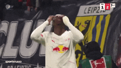 Soccer Player Celebrates Goal In Front Of Leipzig Banner GIF