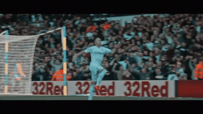 Soccer Player Celebrating Goal In Front Of 32 Red Sign GIF