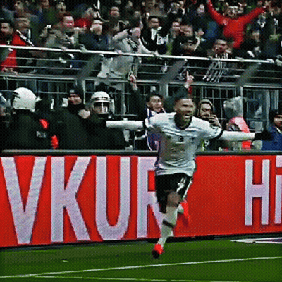 Soccer Player Celebrating Goal In Front Of VKUR Sign GIF