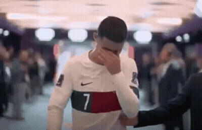 Soccer Player Facepalms, Man In Suit Holds Shoulder GIF