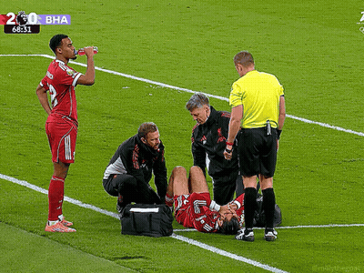 Soccer Player Helped By Doctor And Referee GIF