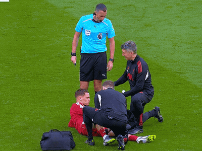 Soccer Player Helped By Referee In Puma Shirt GIF
