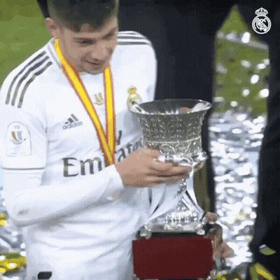 Soccer Player Holding Trophy In Emirates Shirt GIF