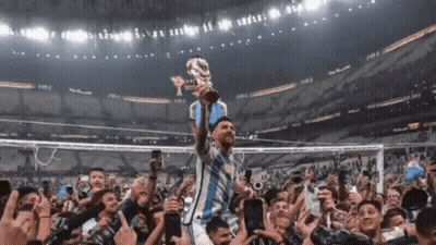 Soccer Player Holding Trophy In Front Of Crowd GIF