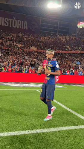 Soccer Player Holding Trophy On Field With Historia GIF